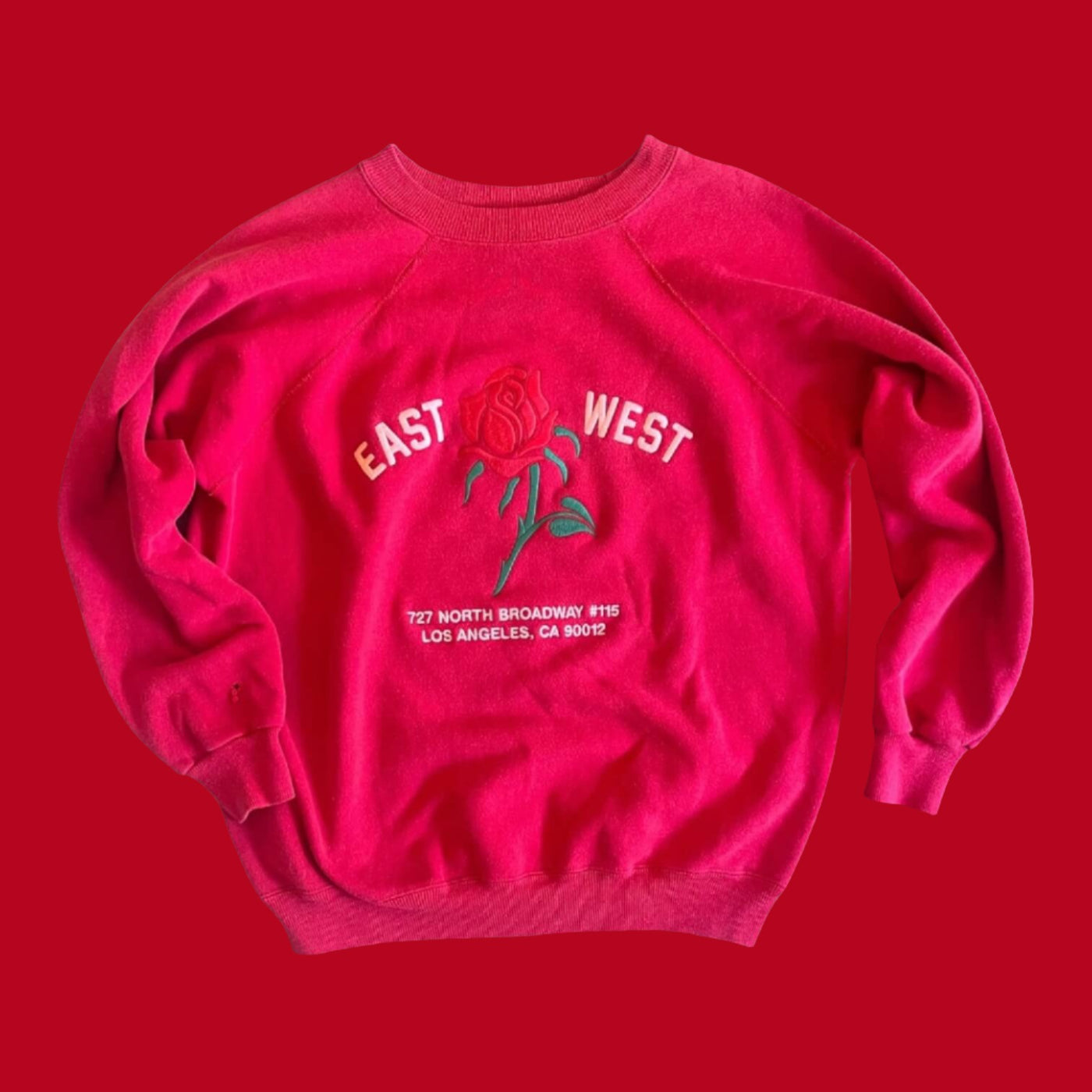 Vintage Sweatshirt with raglan sleeves.  Embroidered with Rose and reads “East West 727 N. Broadway #115, Los Angeles, CA 90012”