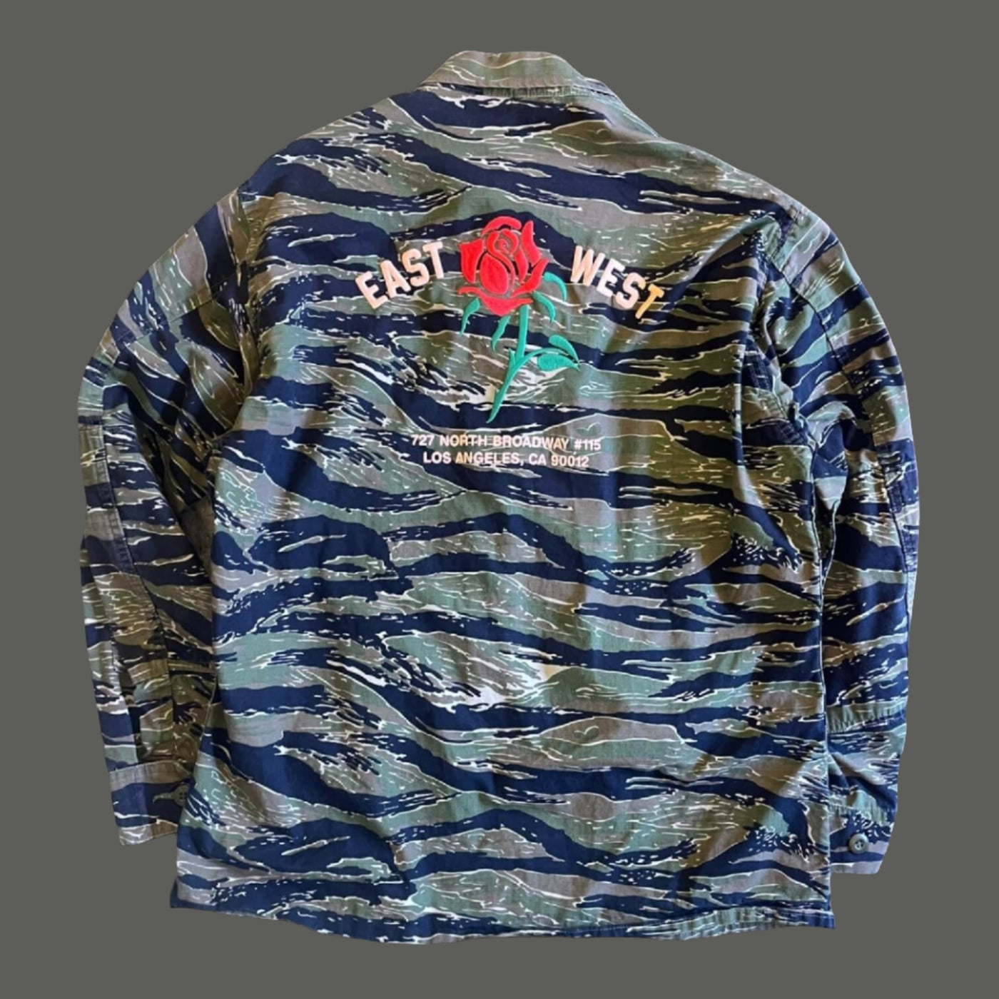 Tiger Camo Jacket  back view - with rose embroidery that reads "East West 727 N. Broadway #115, Los Angeles, CA 90012"