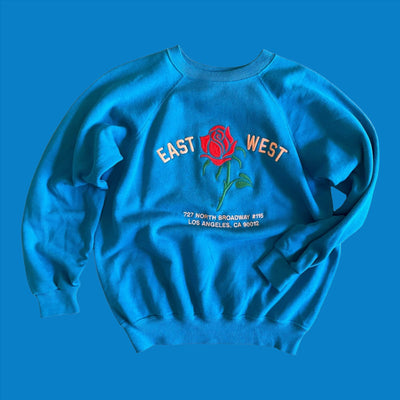 Vintage sweatshirt with embroidery of rose that reads "East West 727 N. Broadway #115, Los Angeles, CA 90012"