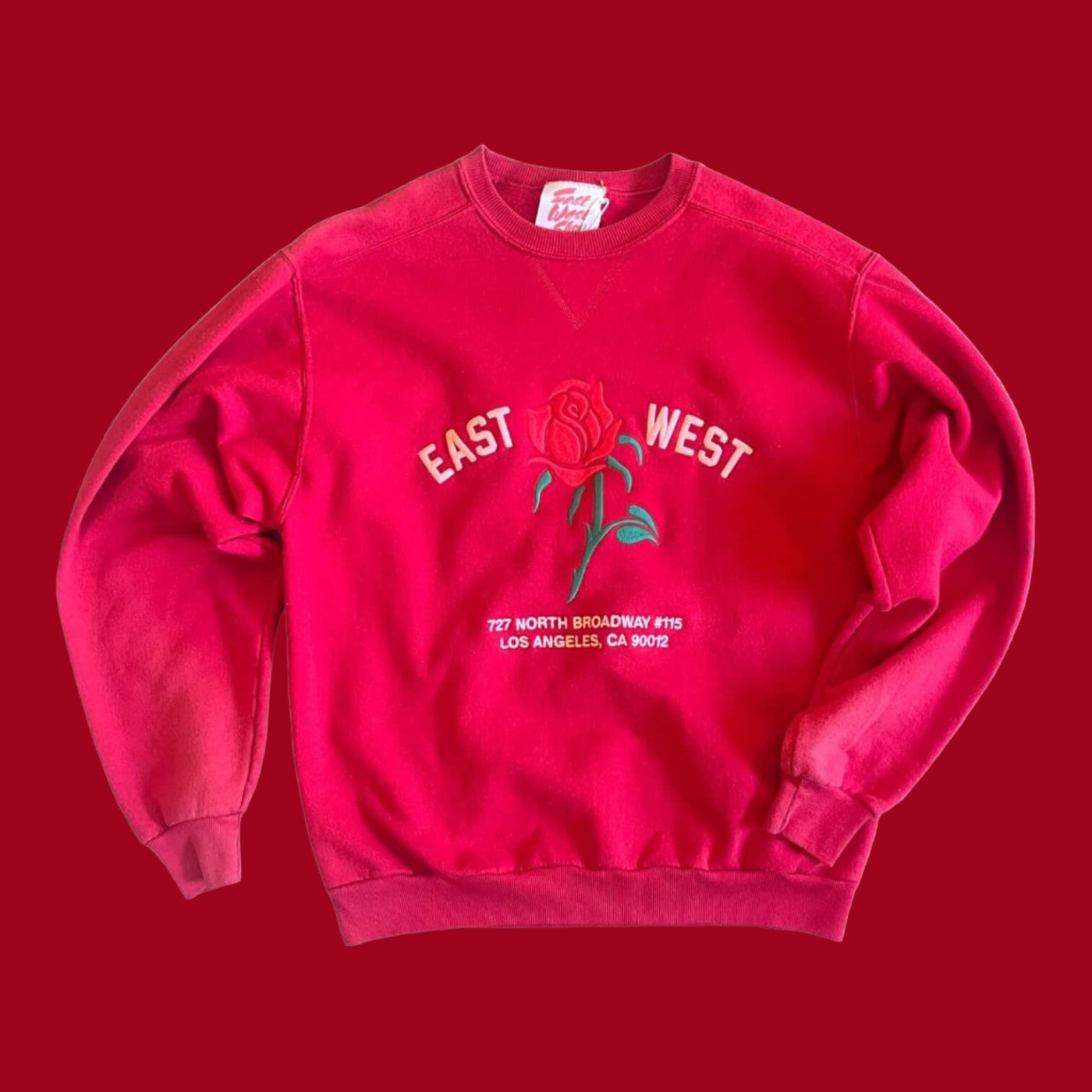 Vintage Sweatshirt with set in sleeves.  Embroidered with Rose and reads “East West 727 N. Broadway #115, Los Angeles, CA 90012”